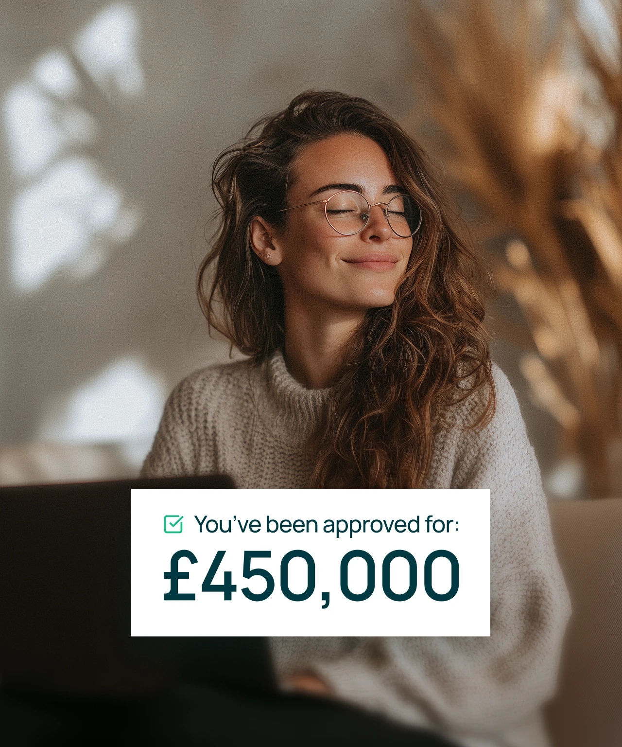 Woman with glasses and long hair smiling and wearing a knitted sweater with text overlay stating approval for £450,000.