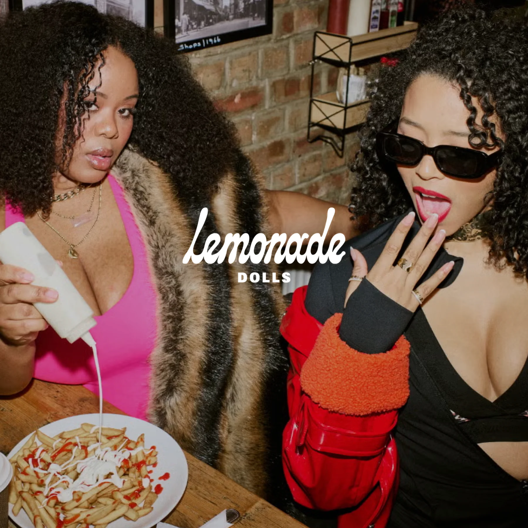 Lemonade dolls logo over image of two women wearing Lemonade dolls products in restaurant setting