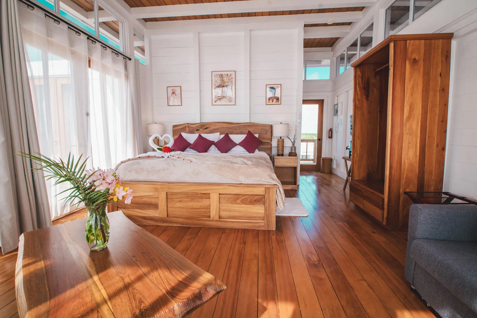 Bright, modern bedroom with wooden furnishings, large bed, and balcony view.