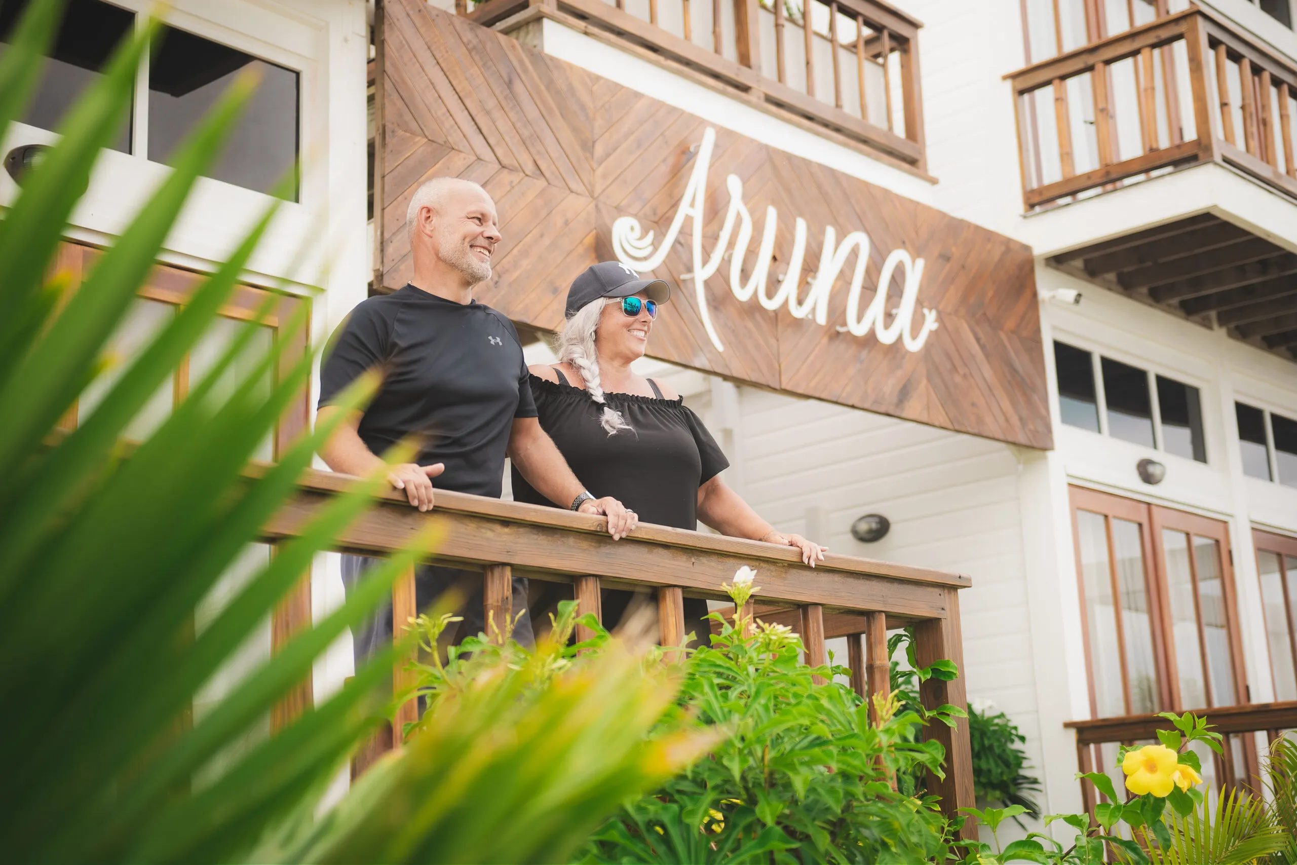 Couple enjoying balcony view at Aruna Resort.