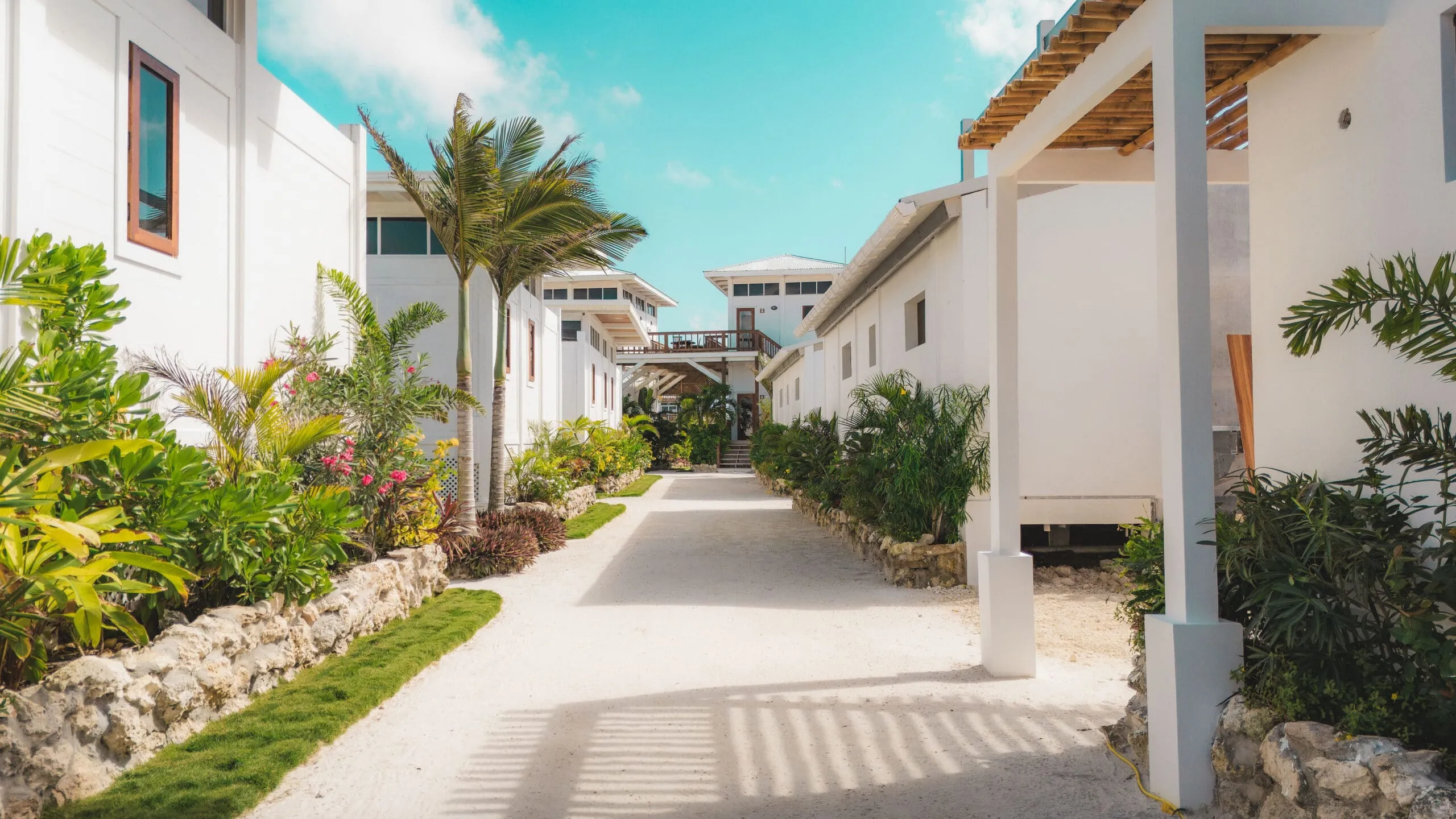 Tropical pathway connecting villas and resort grounds.