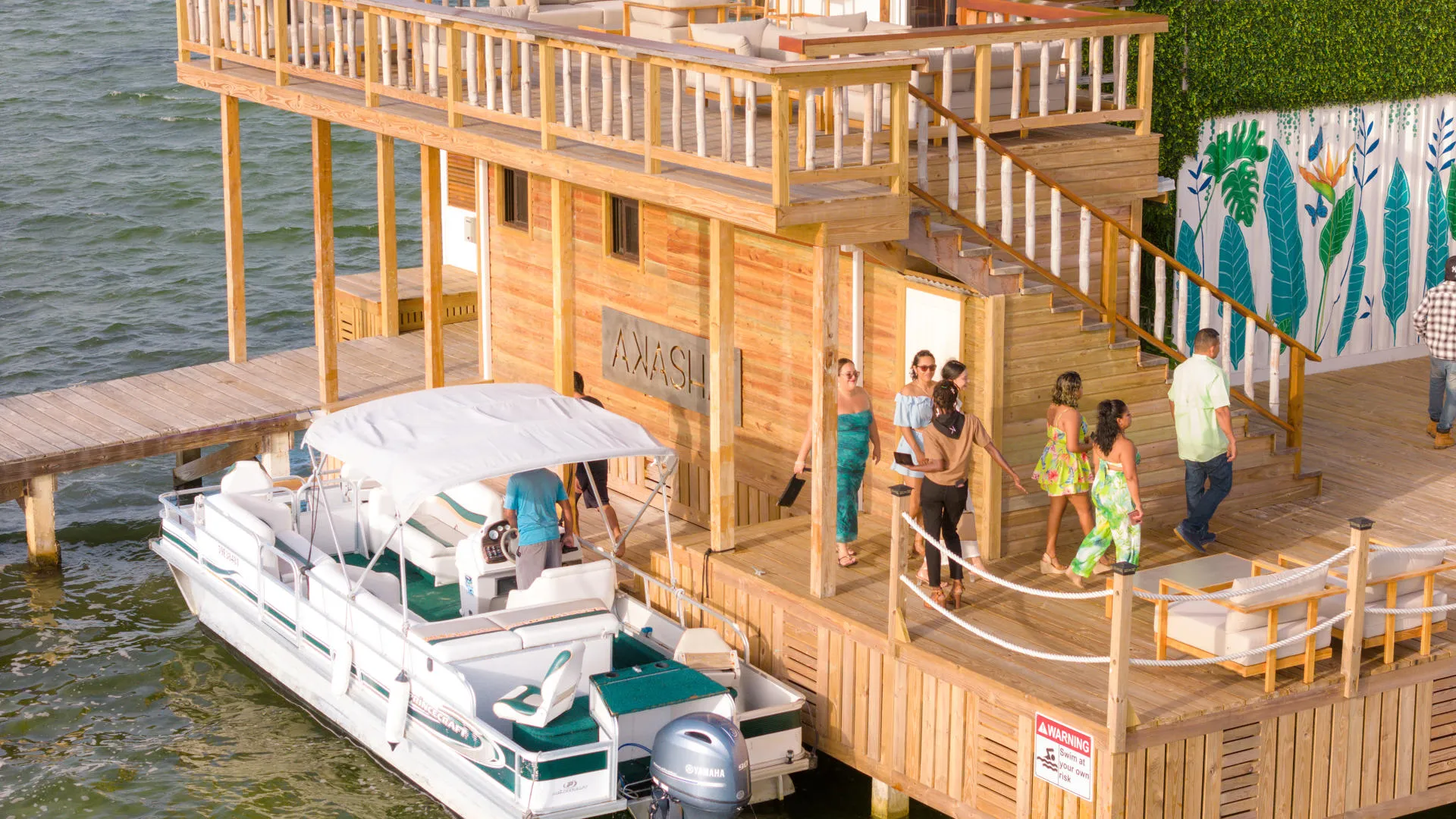 Guests arriving at Akasha restaurant dock by boat.