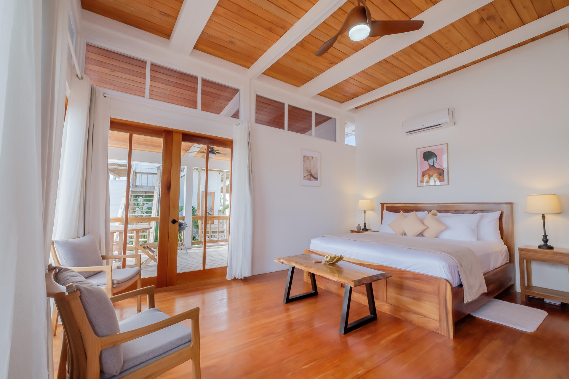 Modern bathroom with double vessel sinks, round wooden mirrors, and a walk-in tiled shower.
