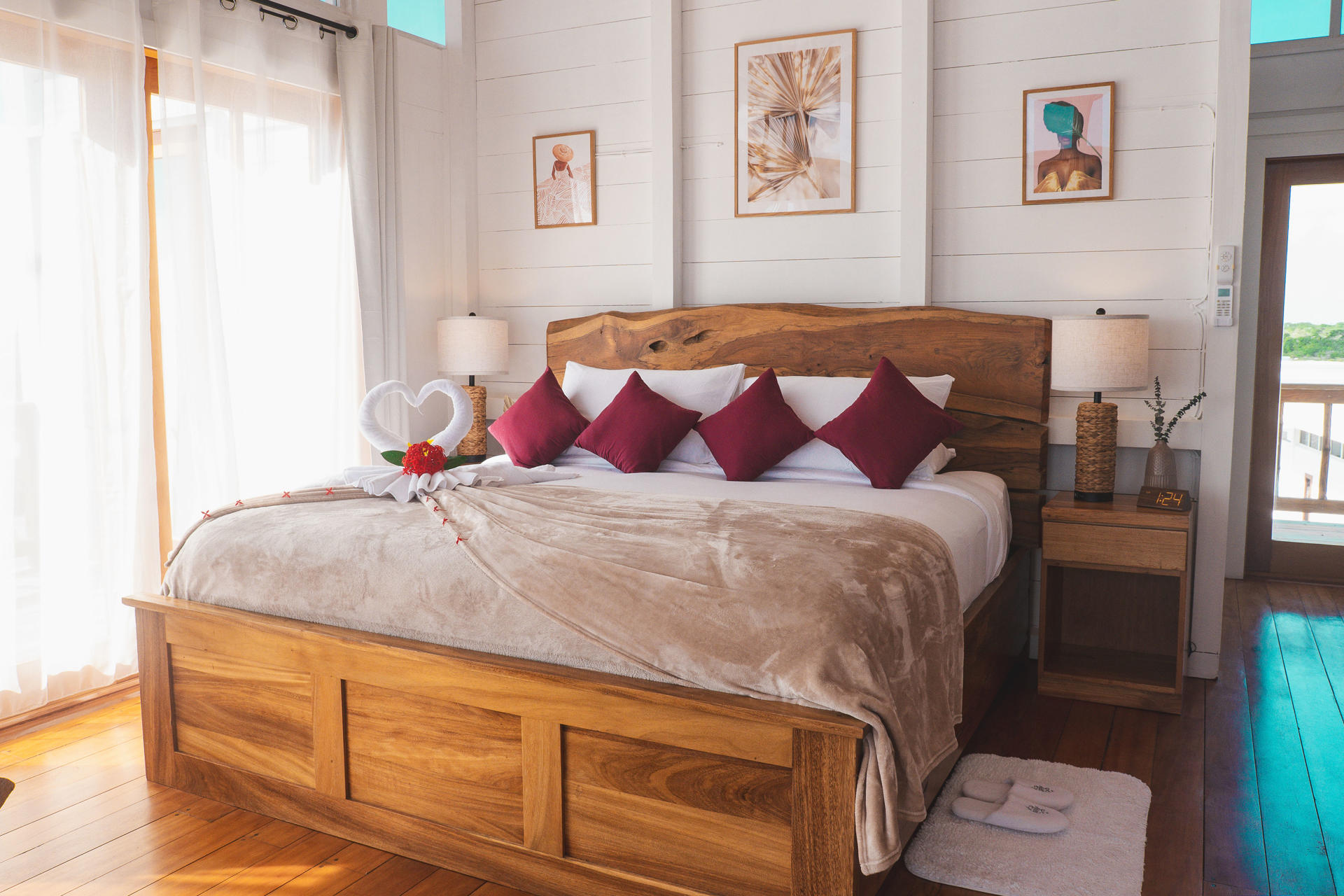 Spacious bedroom with wooden ceiling, king bed with neutral linens, and wooden wardrobe.