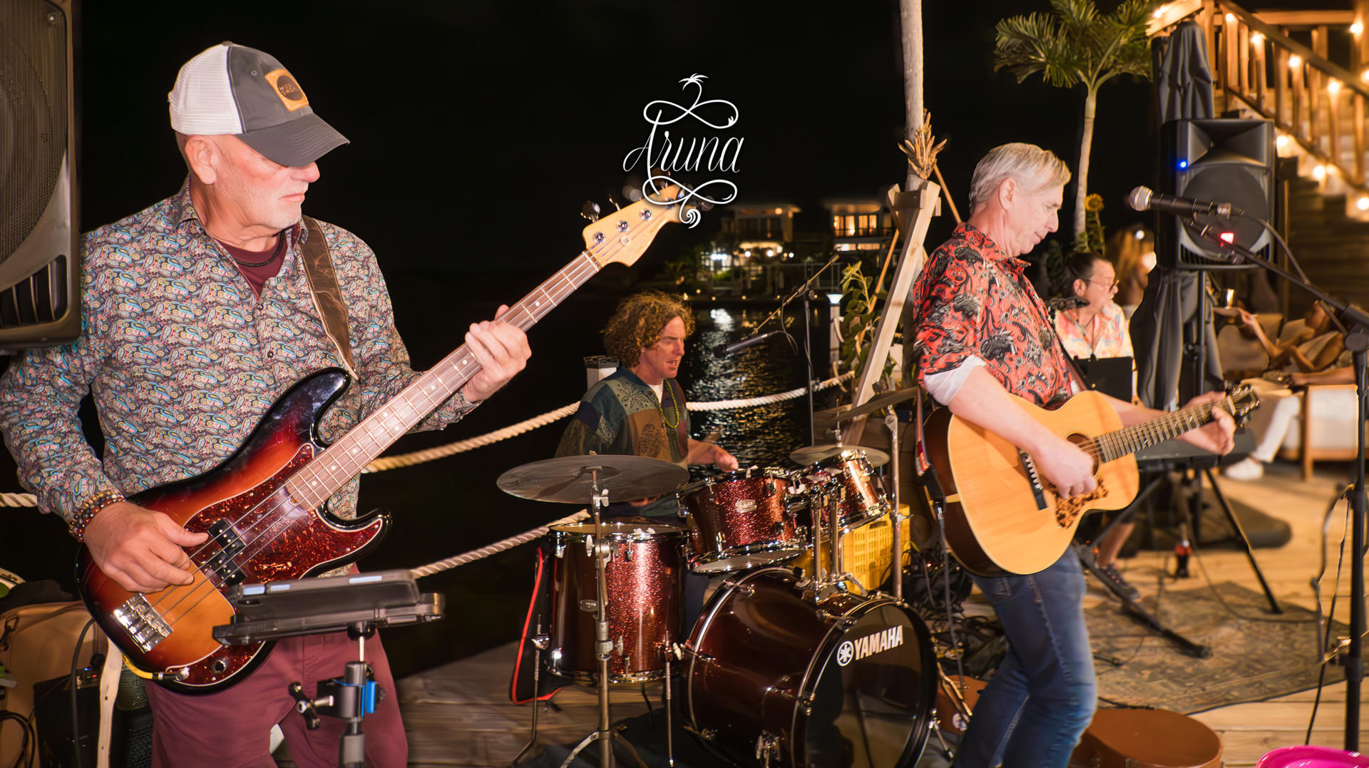 Live band playing beside the water at Aruna Resort at night