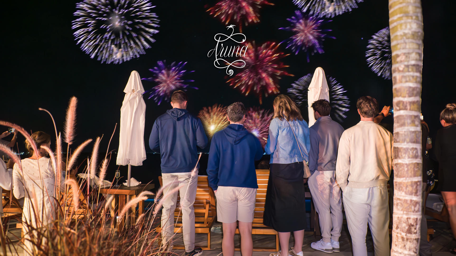 Guests watching New Year's fireworks from the deck at Aruna Resort