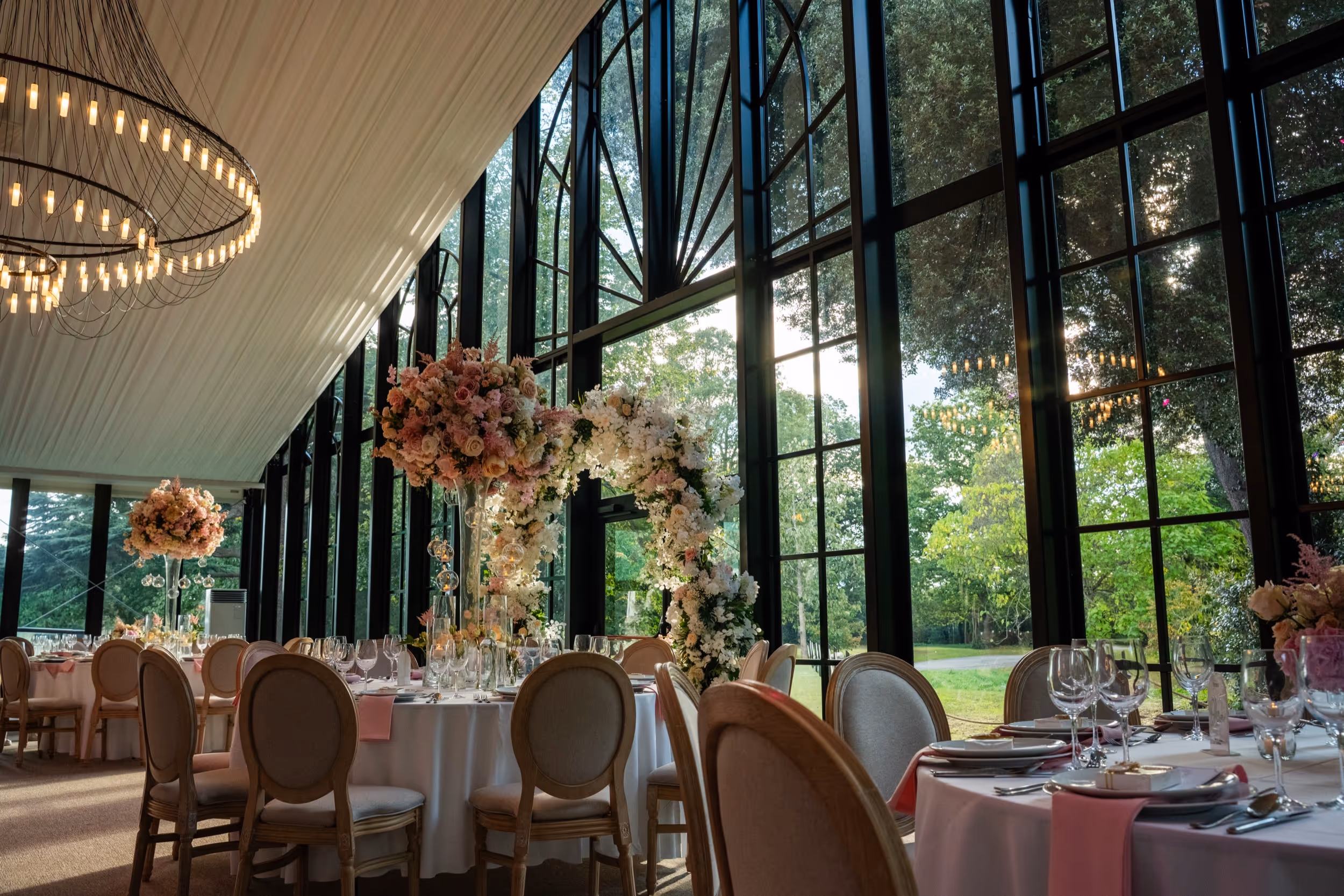 Woodland ceremonies. Lawn receptions. Five custom chandeliers. Your entire wedding within one private estate in historic Syon Park, May through September.