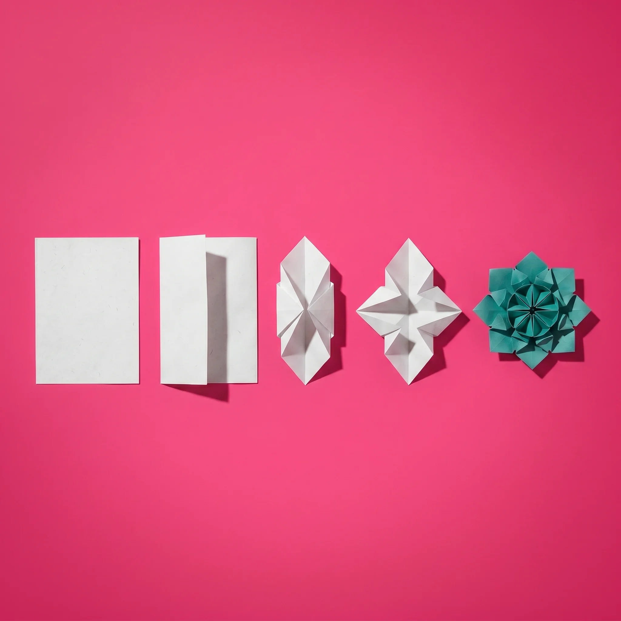 Five-step origami process from flat white paper to a folded teal flower on a pink background.