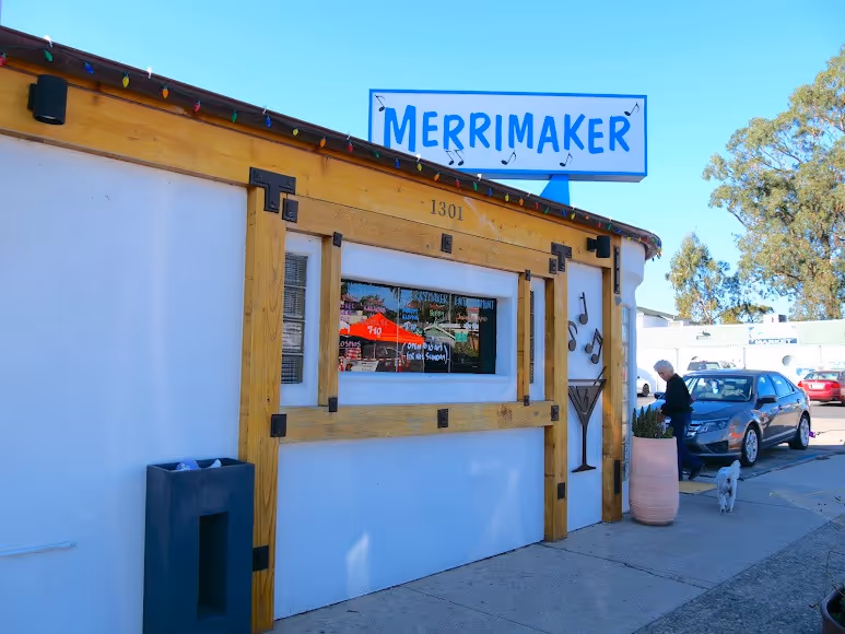 A white building with a visible sign displayed on it.