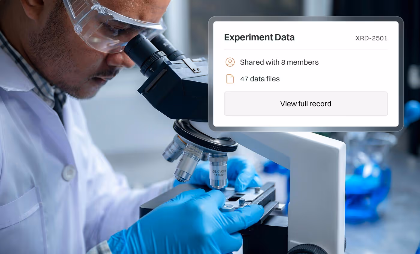 Scientist wearing safety goggles and blue gloves examining a sample under a microscope with an overlay showing experiment data shared across an academic research team.