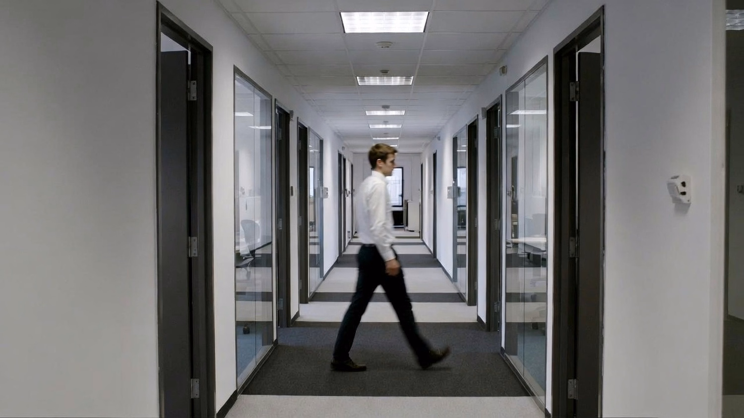 WALKING CORRIDOR An IT professional  one or two people walking mid-stride thr