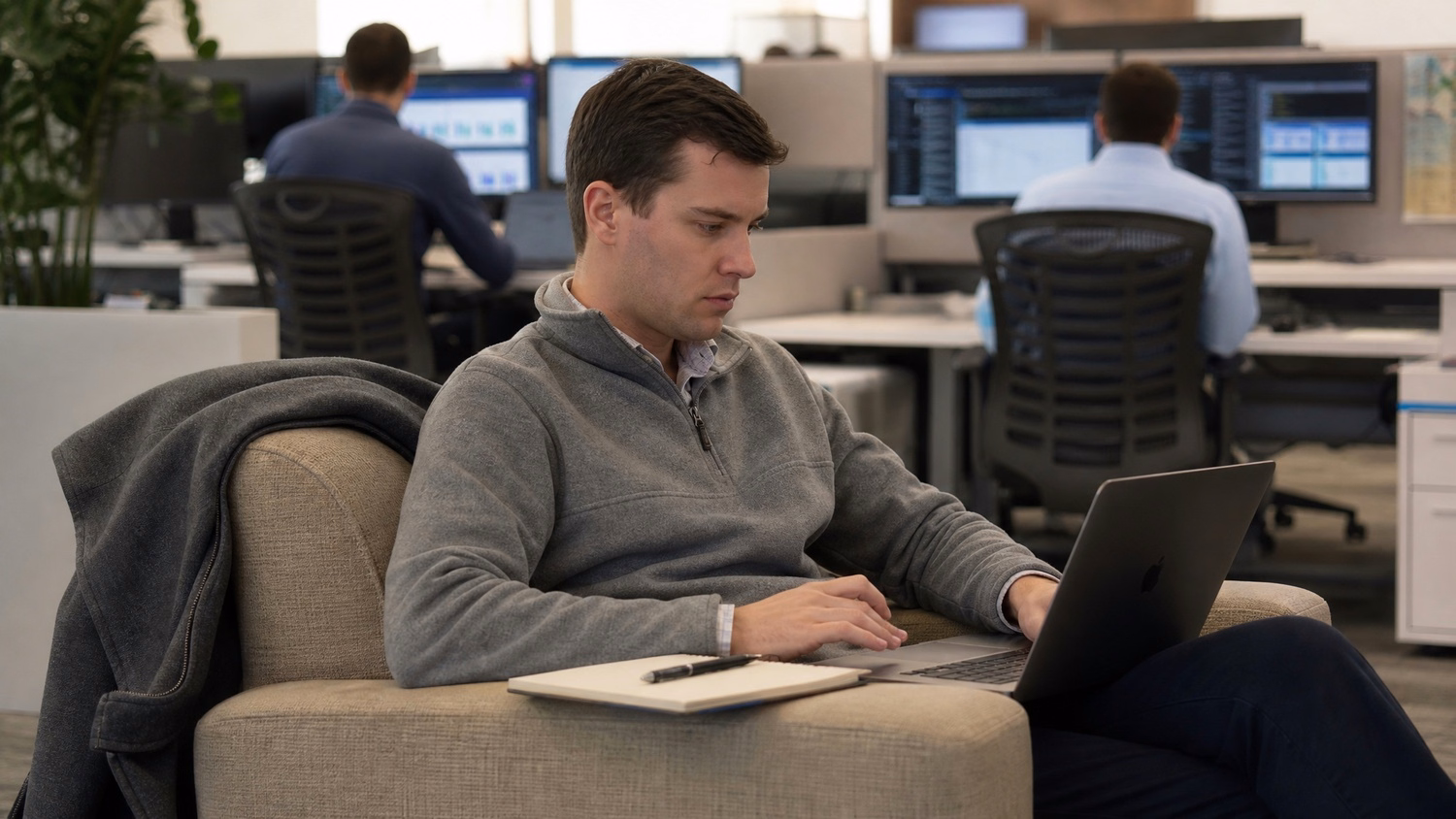 Consultant working on laptop in office lounge chair 59 chars