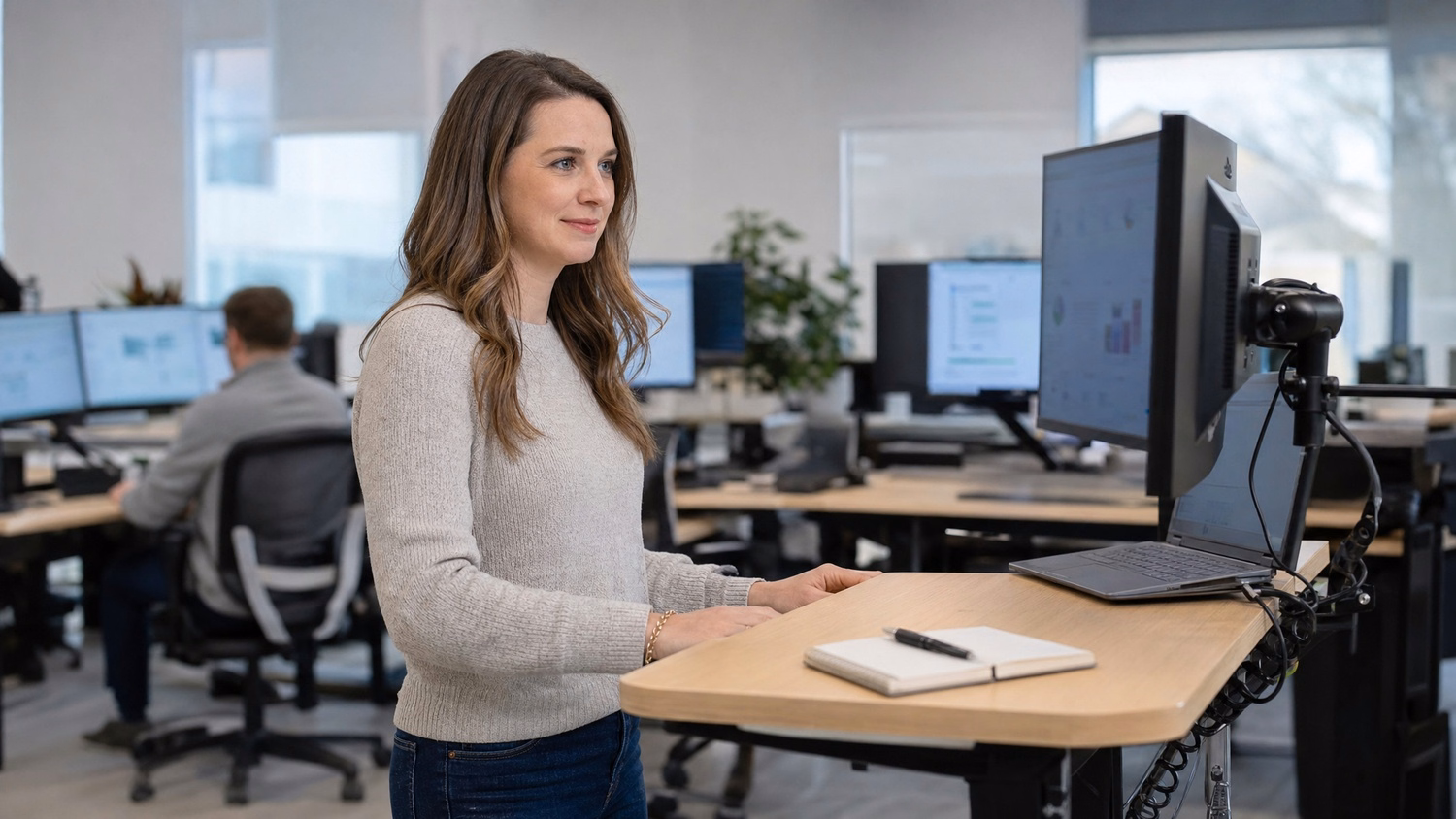 Woman at standing desk reviewing compliance audit data 62 chars