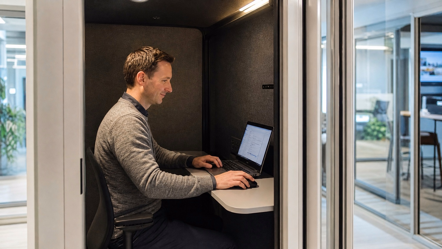 Woman coding late at desk, warm lamp light, screen glow