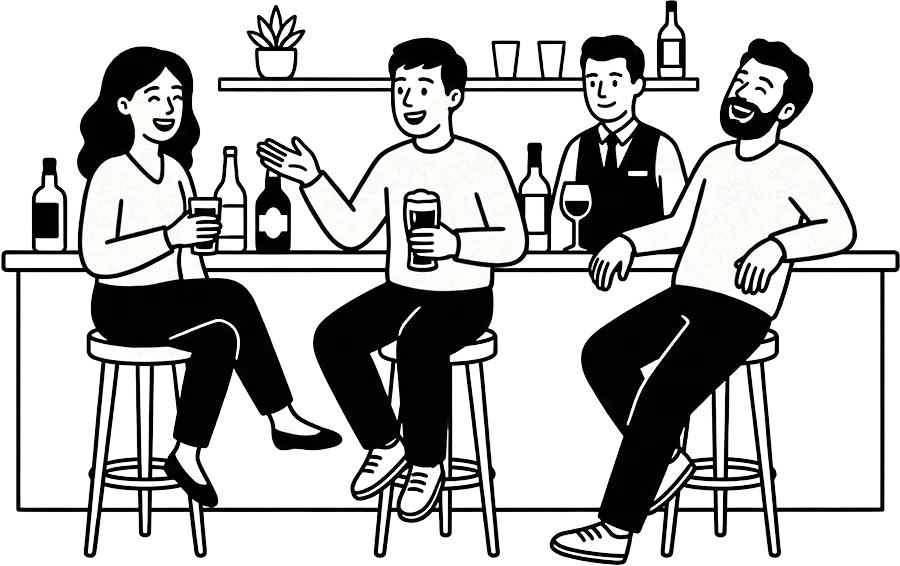 Three people sitting on bar stools holding drinks while a bartender stands behind the bar with bottles and glasses on shelves.