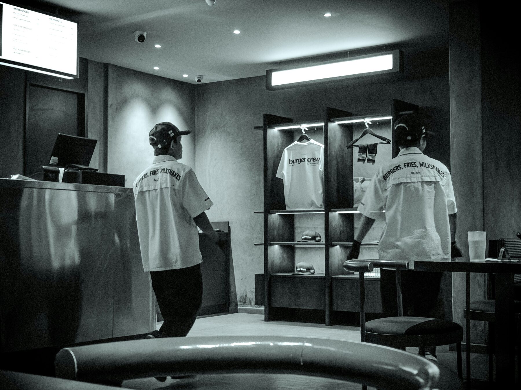 Hospitality crew in branded workwear at a counter