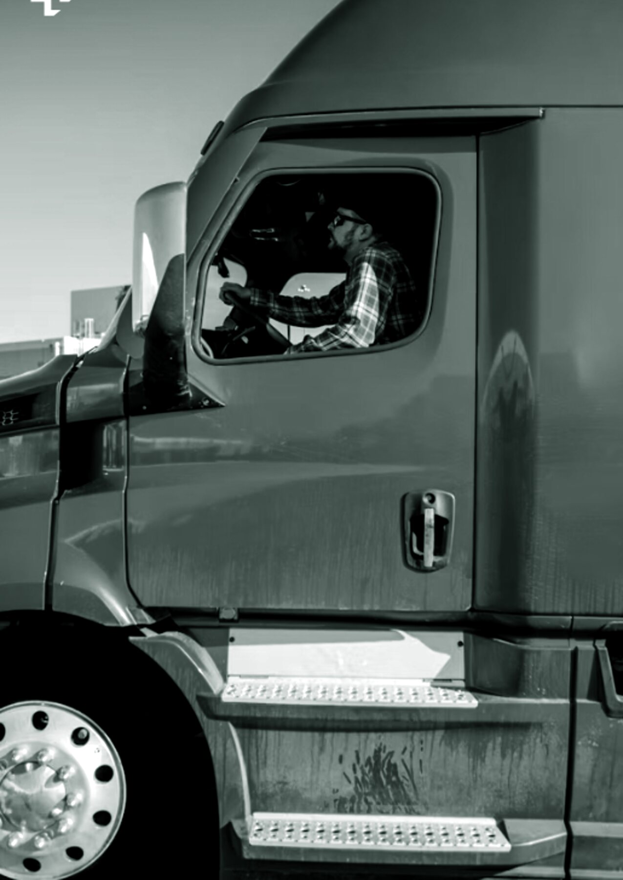 HGV driver at the wheel of a truck cab