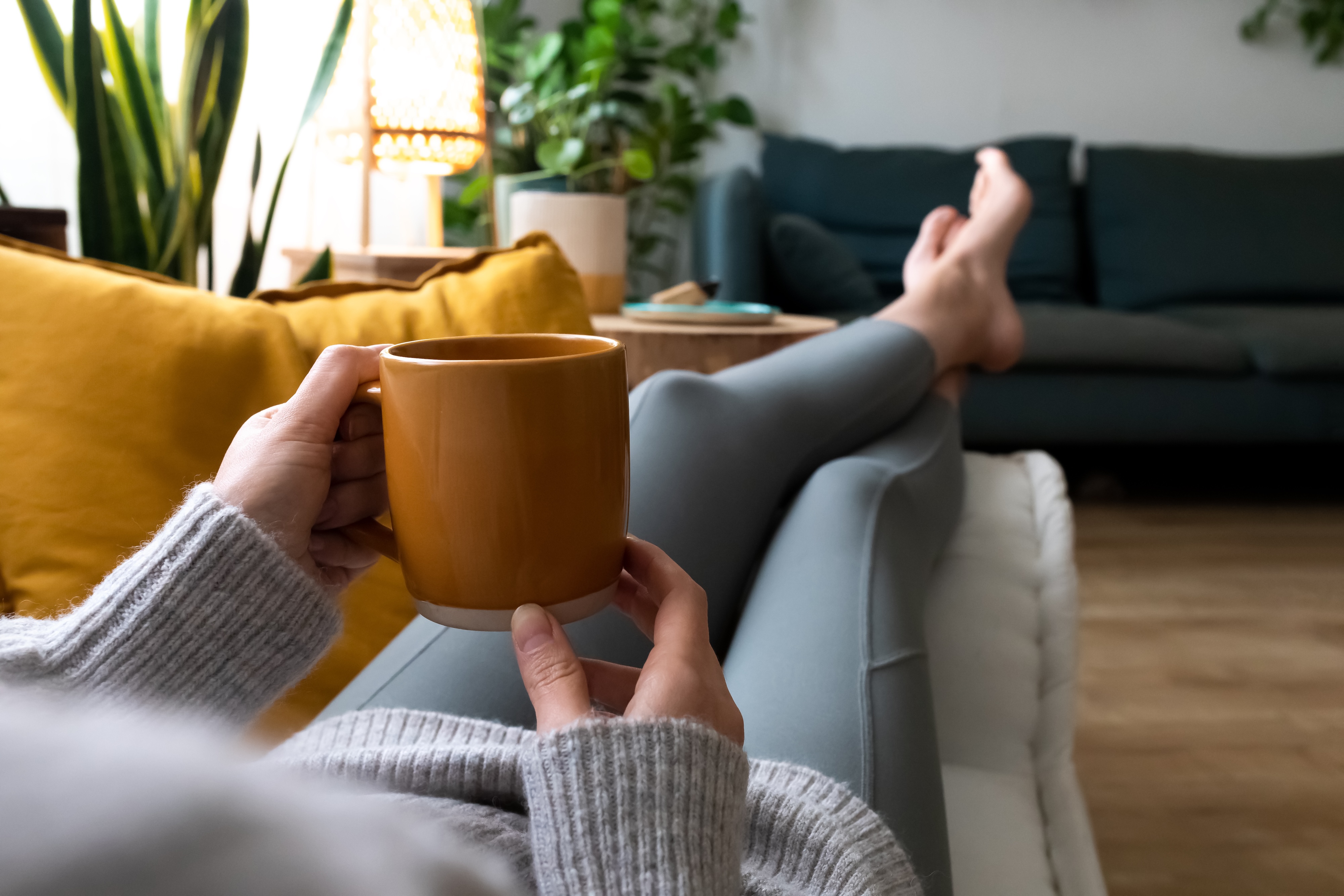 Drinking coffee on couch stock image