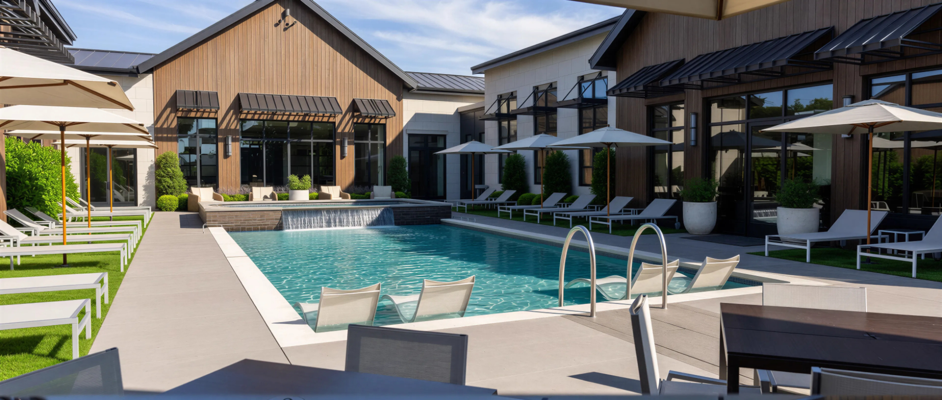 Exterior of pool rendering with lounge chairs and view of clubhouse 