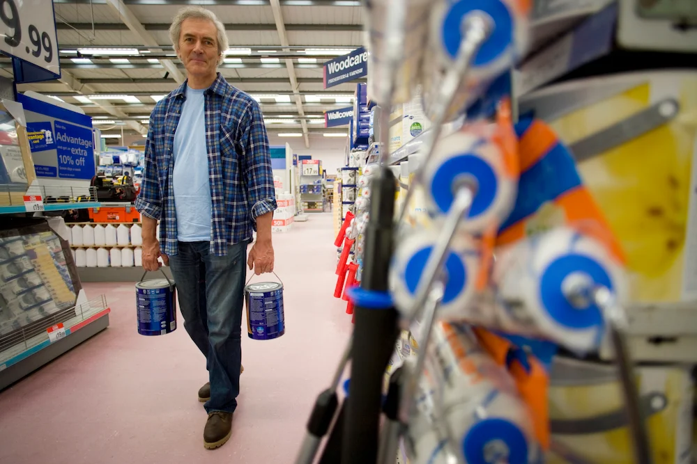 man shopping for paint supplies