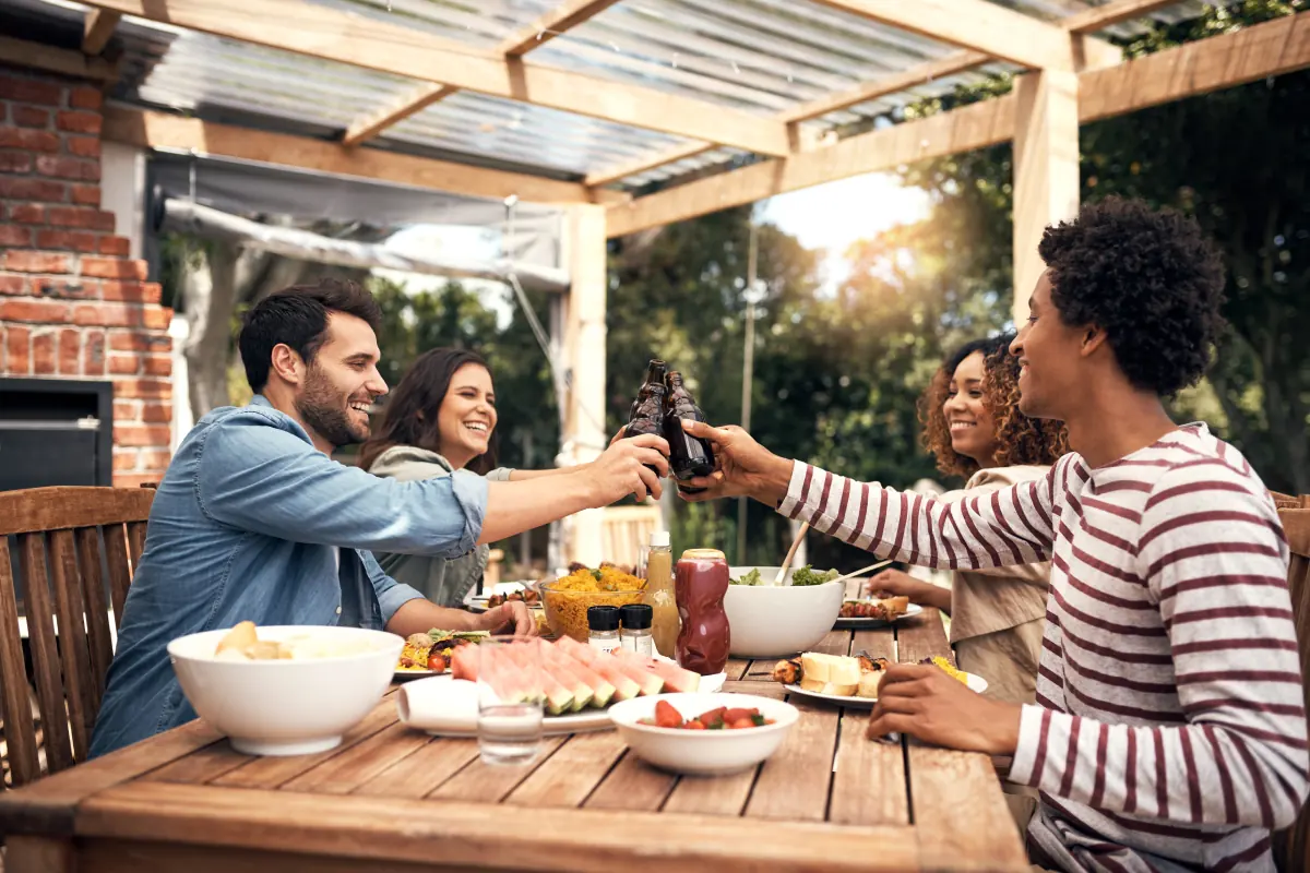 people cheersing in backyard dining area