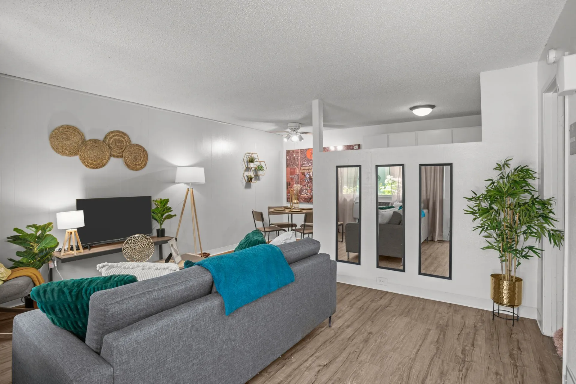 view of living area with sofa, tv and view of dining area