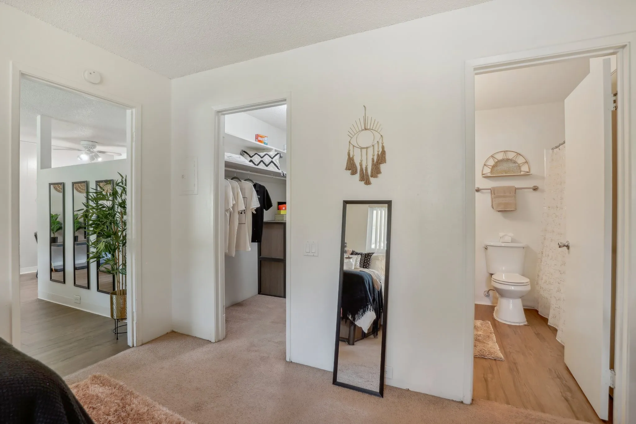 view of bathroom, closet, and hallway from inside bedroom