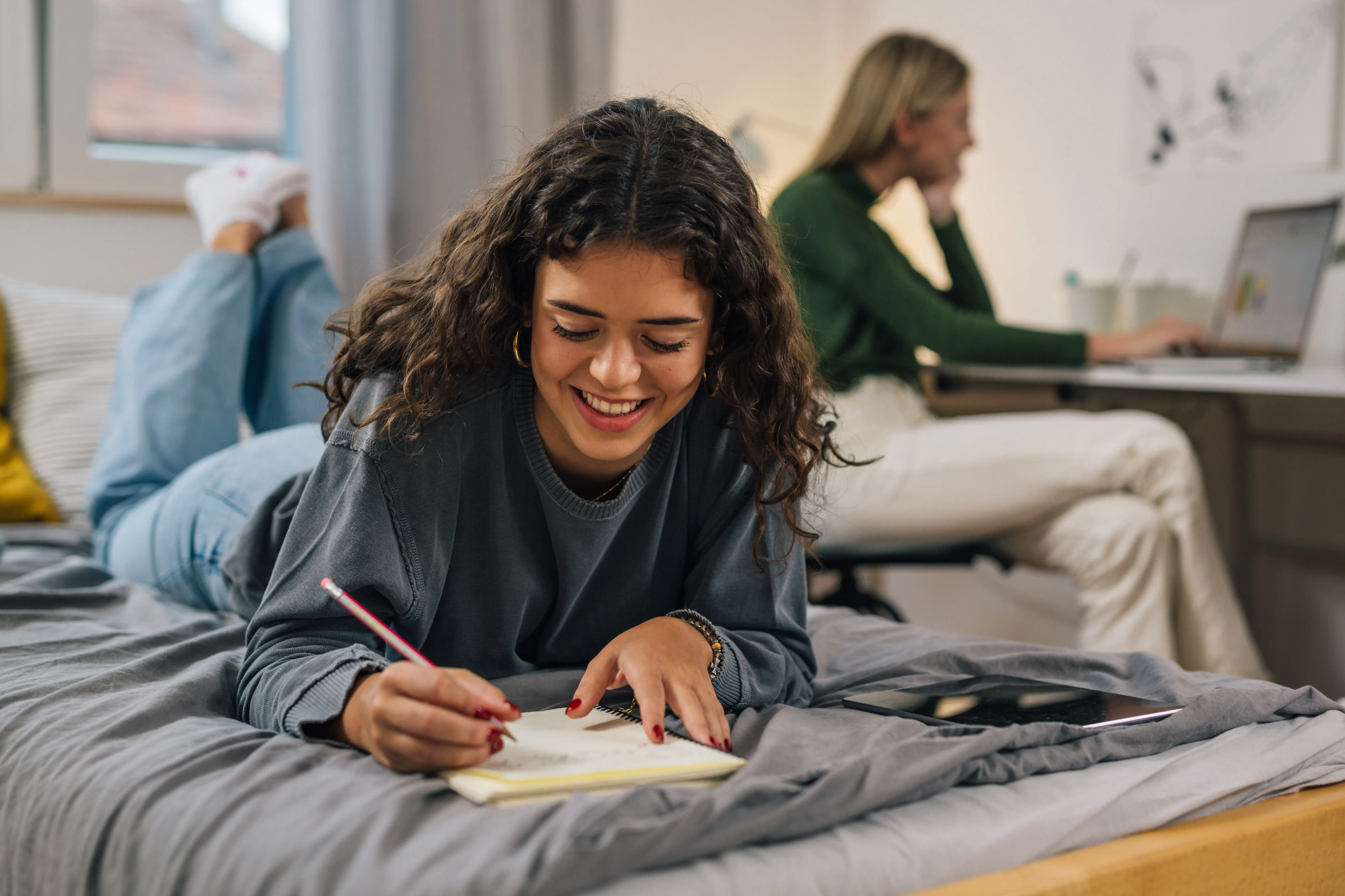 girl writing while in bed stock image