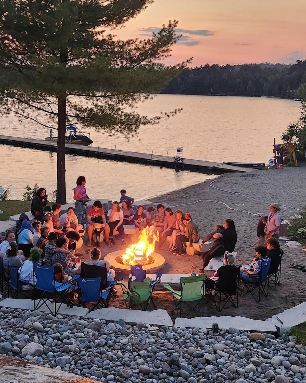 Camp USA participants gathered around a campfire during summer cultural exchange program