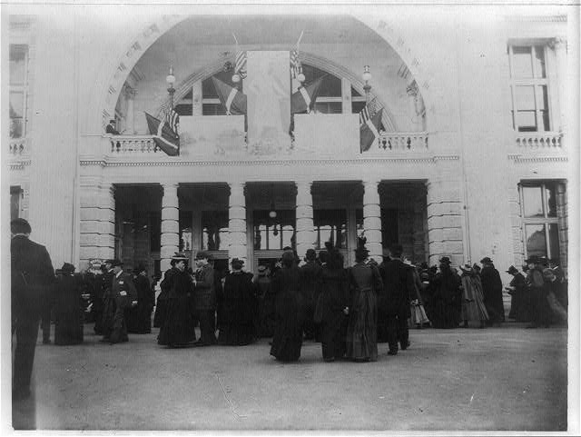 people at the world's fair in chicago entering a building with the I Will symbol built into the arch way