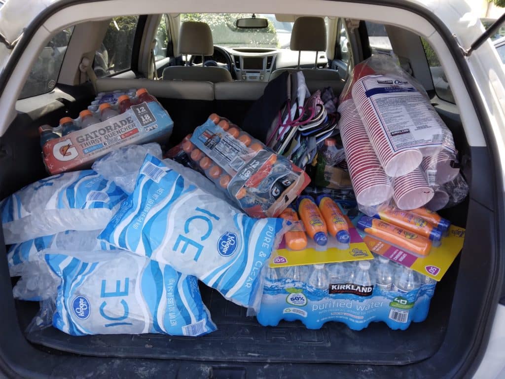 Car trunk full of bottled water, Gatorade and ice.