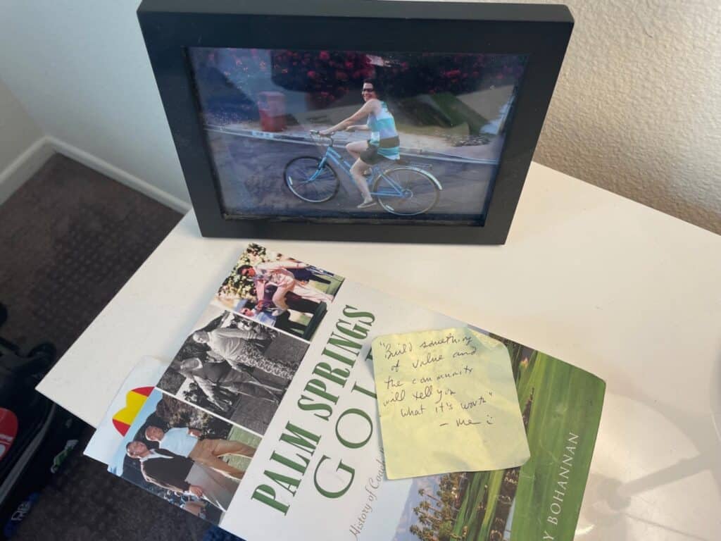A sticky note on a golf booklet reads "Build something of value and the community will tell you what it's worth."