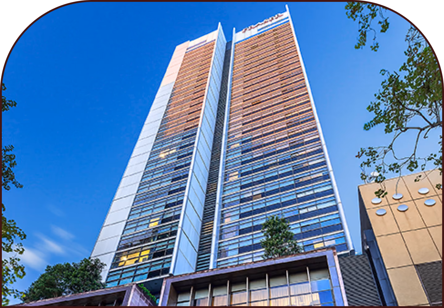 Exterior view of the office building in Sydney's CBD that houses The Reco Lab studio, photographed against a clear blue sky.