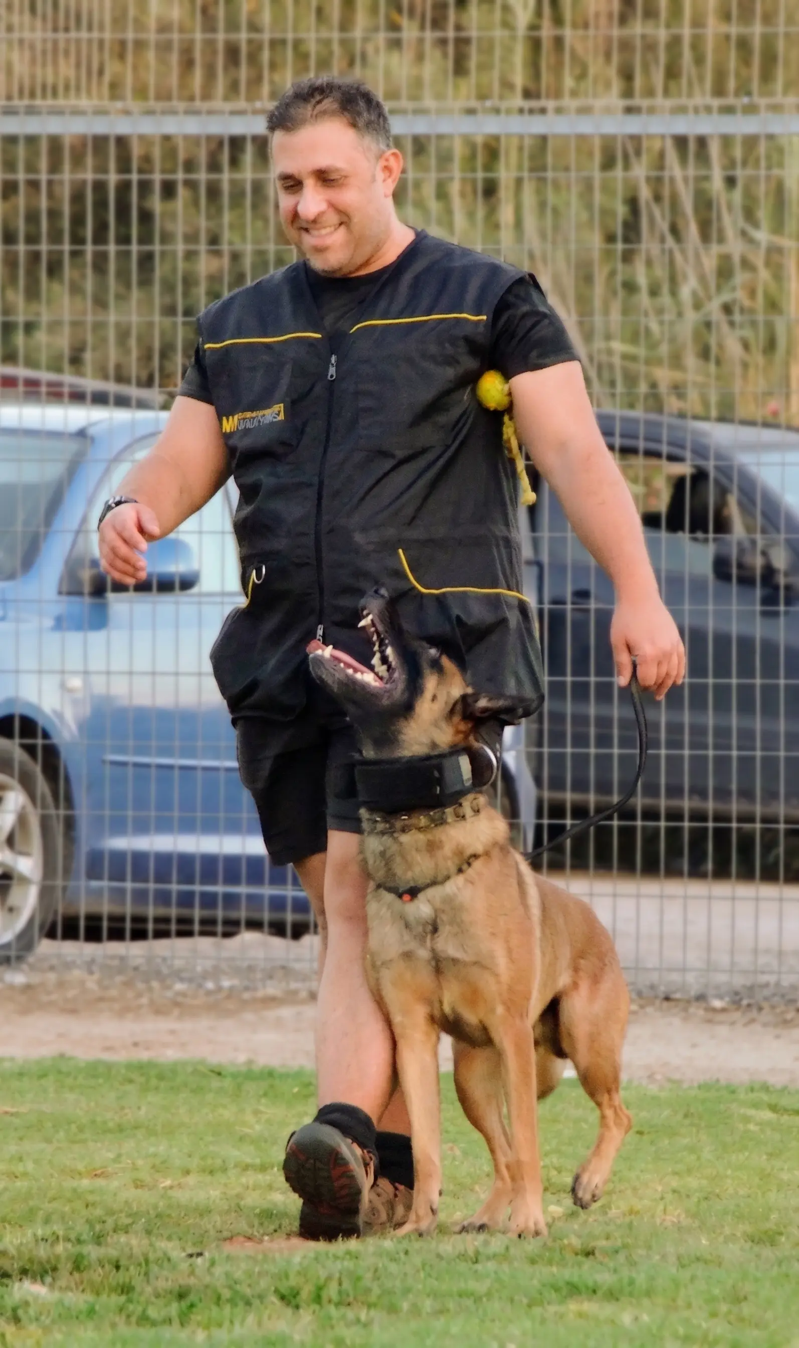 DogBase founder Almog Koren training his Belgian Malinois Echo on a K9 training field