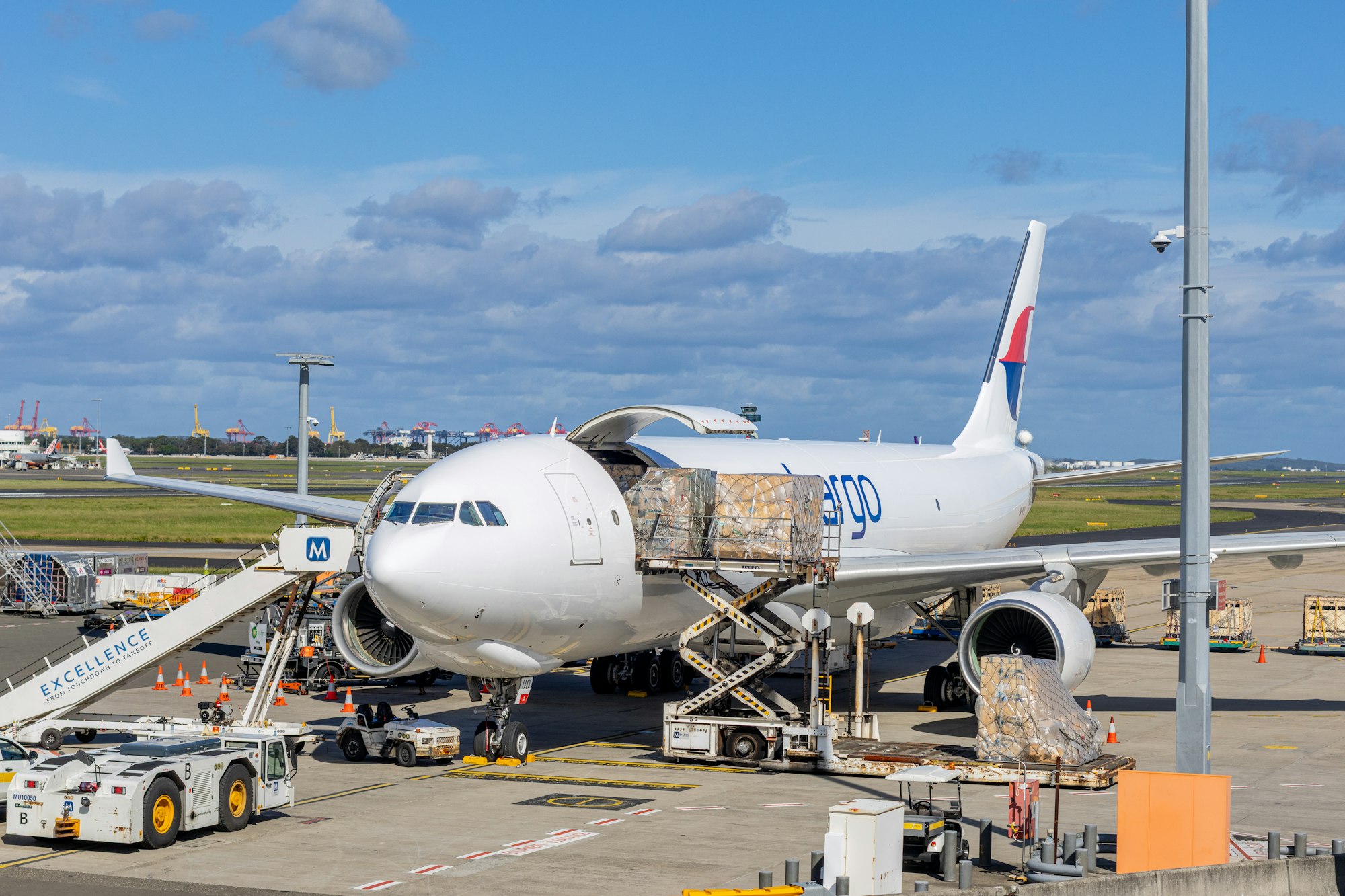 Cargo plane being loaded on an airport tarmac.