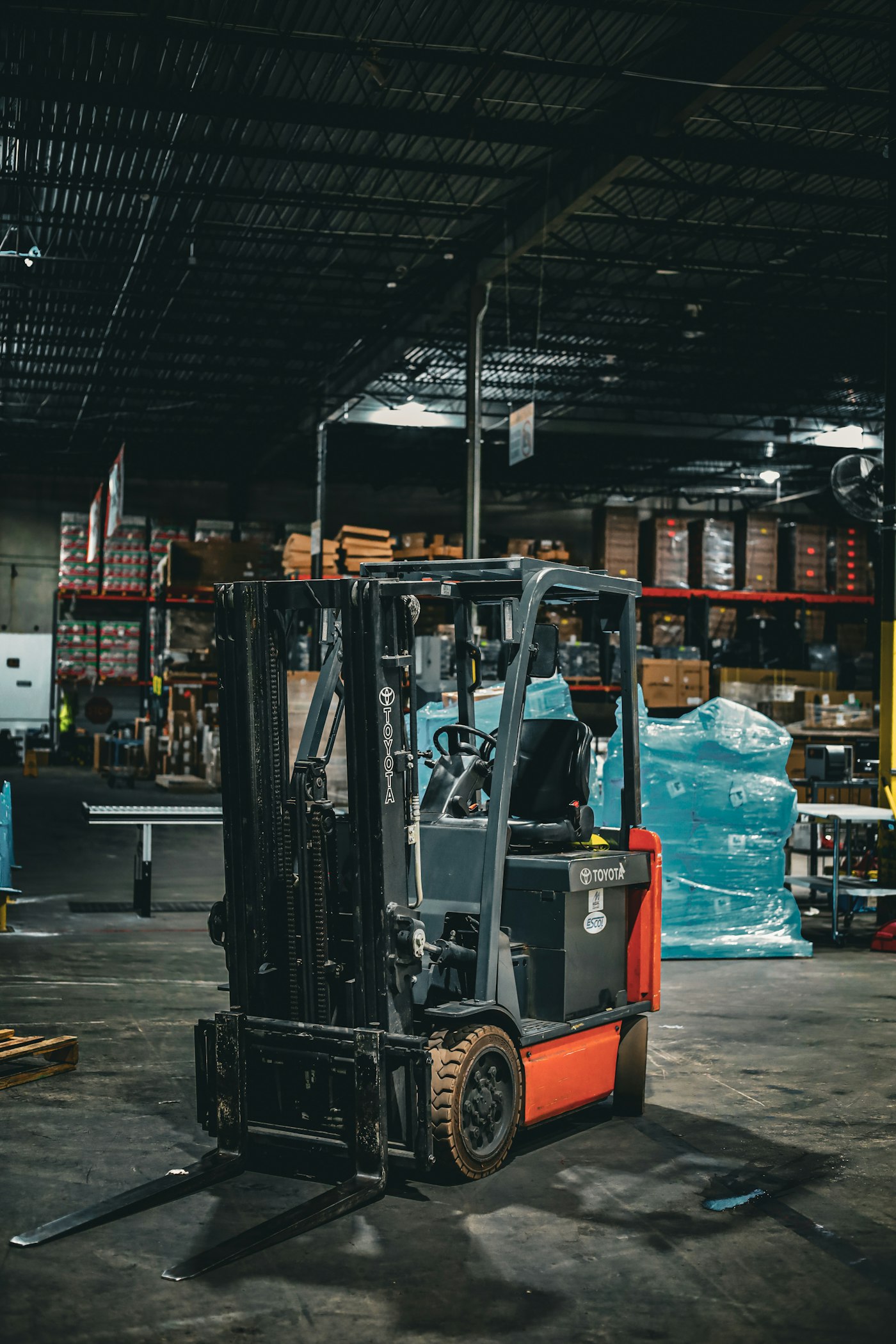 Forklift parked inside a freight warehouse.