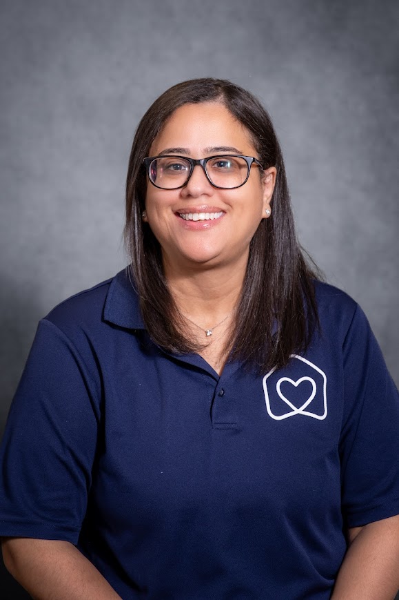 Amarilis Castillo smiling in navy school staff polo shirt