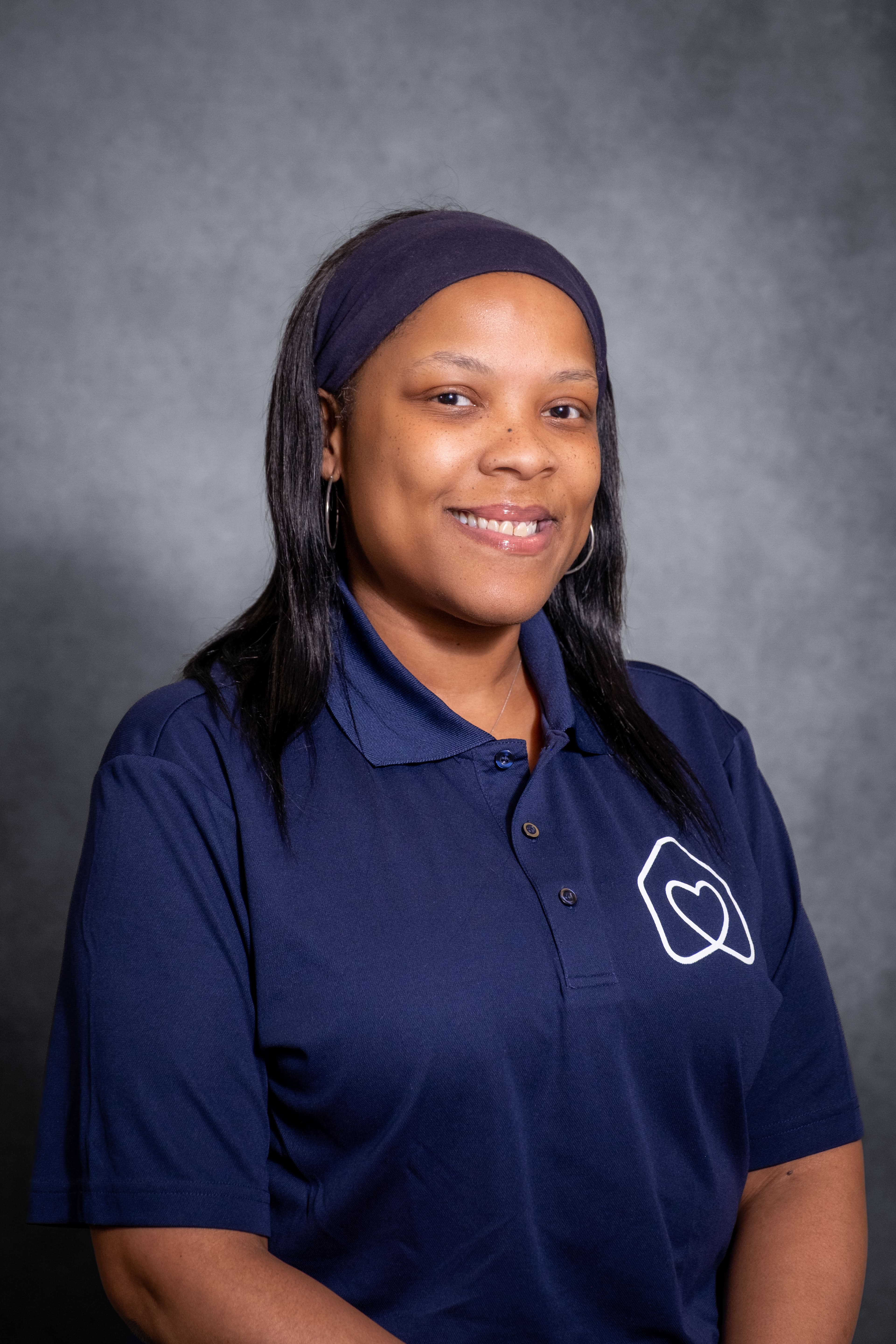 Staff portrait of Charonda Pratt in navy polo shirt