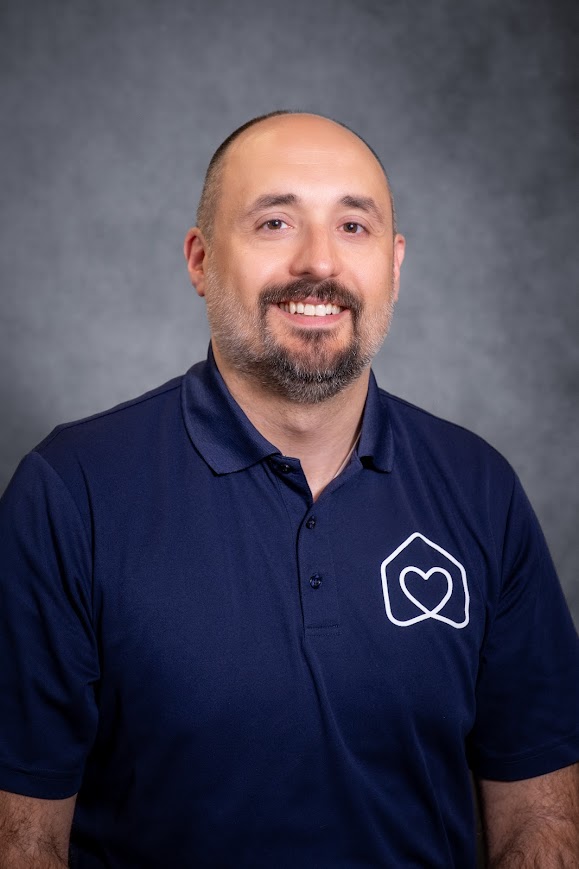 Salvatore Birardi staff headshot smiling in navy polo shirt