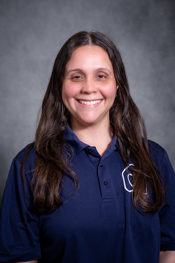 Benelly Alvarez smiling in a navy school polo shirt