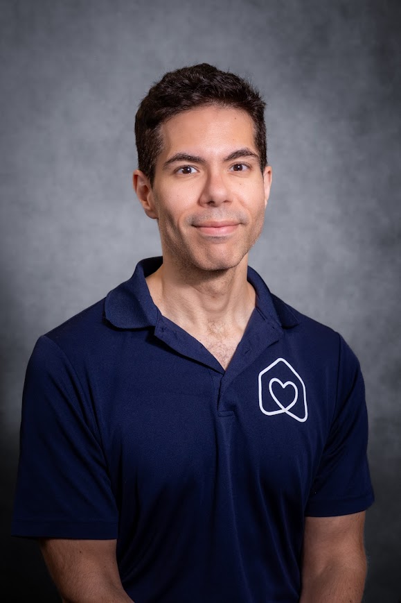 Peter Previti staff headshot in navy Hearts team polo