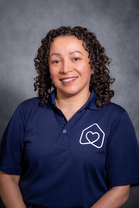 Sara Davila-Hamue smiling in navy school staff polo shirt