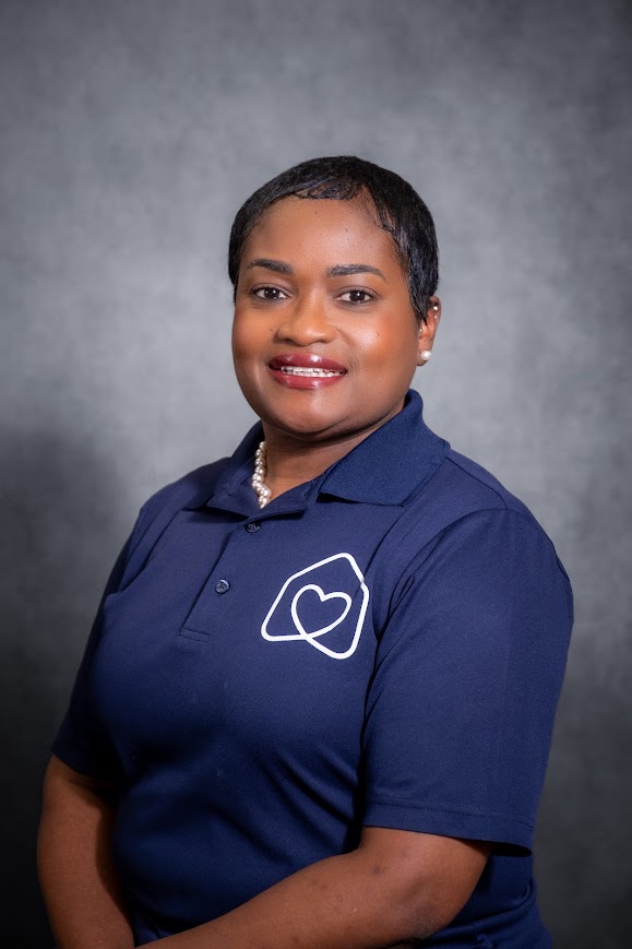 Dr. Tanicia Rivera smiling in navy Hearts team polo shirt