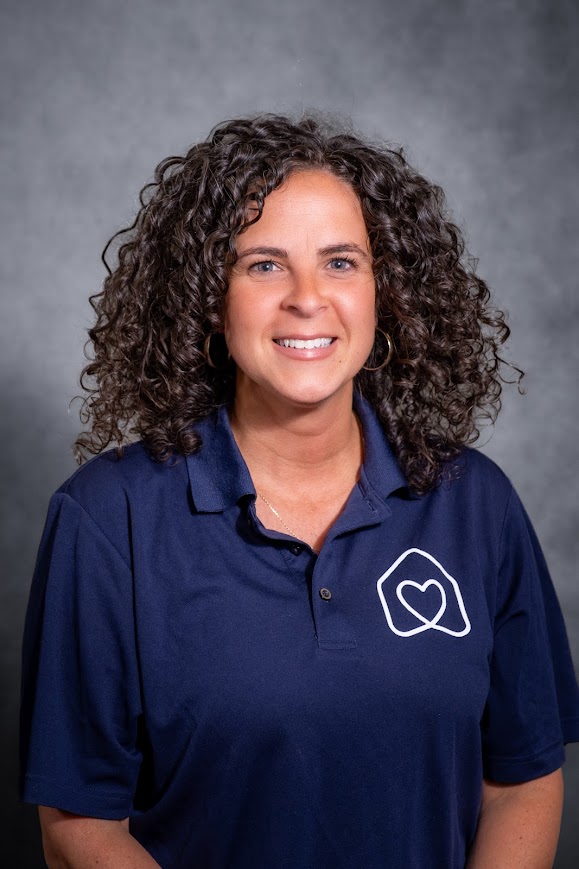 Jessica Rosinsky smiling in navy school staff polo shirt