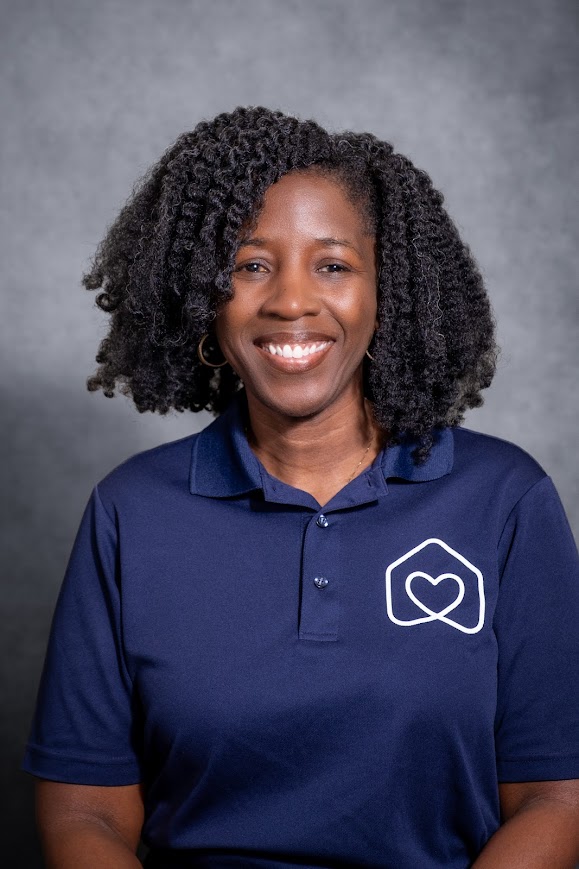 Julia King smiling in a navy blue staff polo shirt