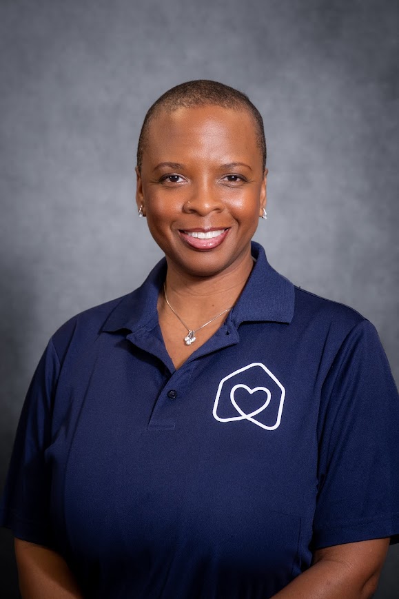 Cherie Umstead smiling in navy Hearts team polo shirt