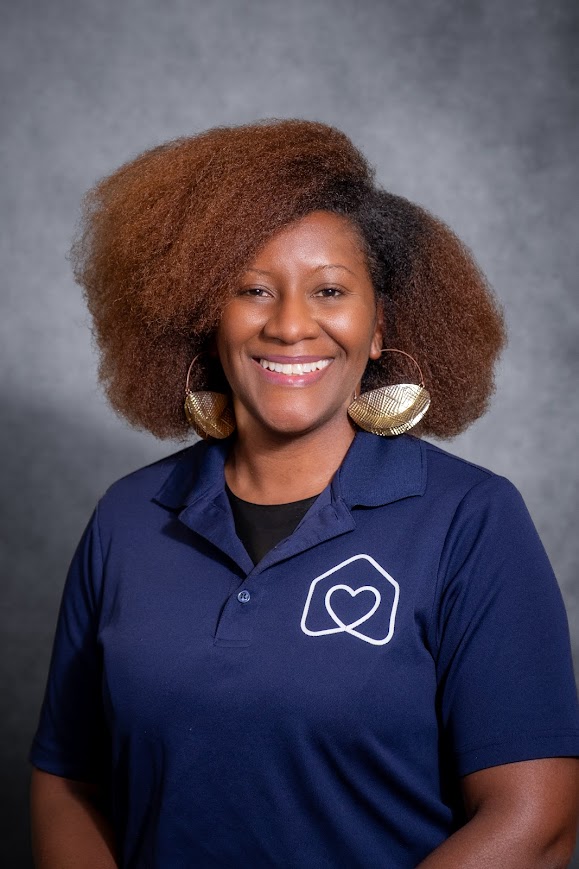 April Gurley smiling in a navy school staff polo shirt