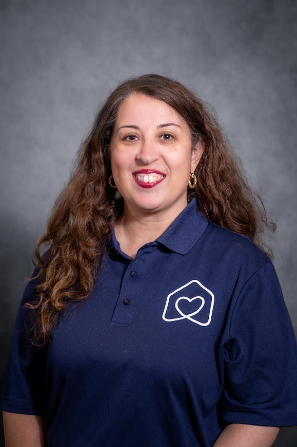 Staff member Erin Edwards smiling in school uniform polo shirt