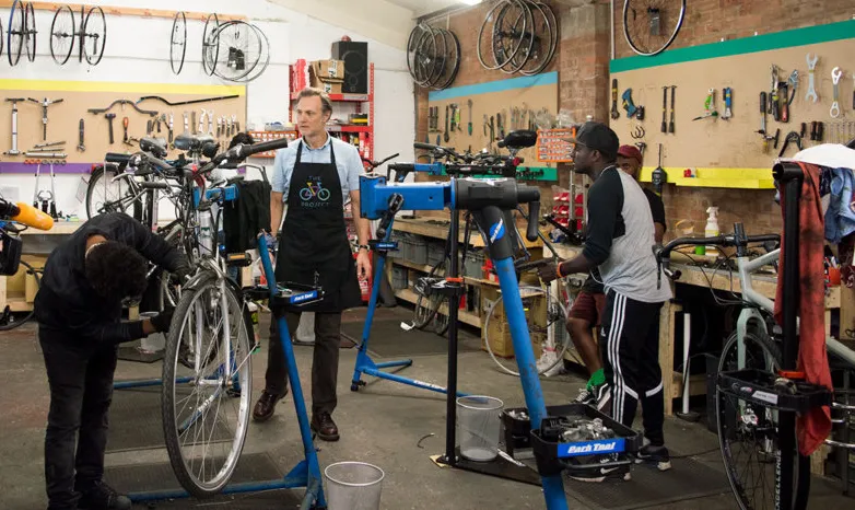 An image of bicycles being worked on at a workshop as part of the Go Well Fund