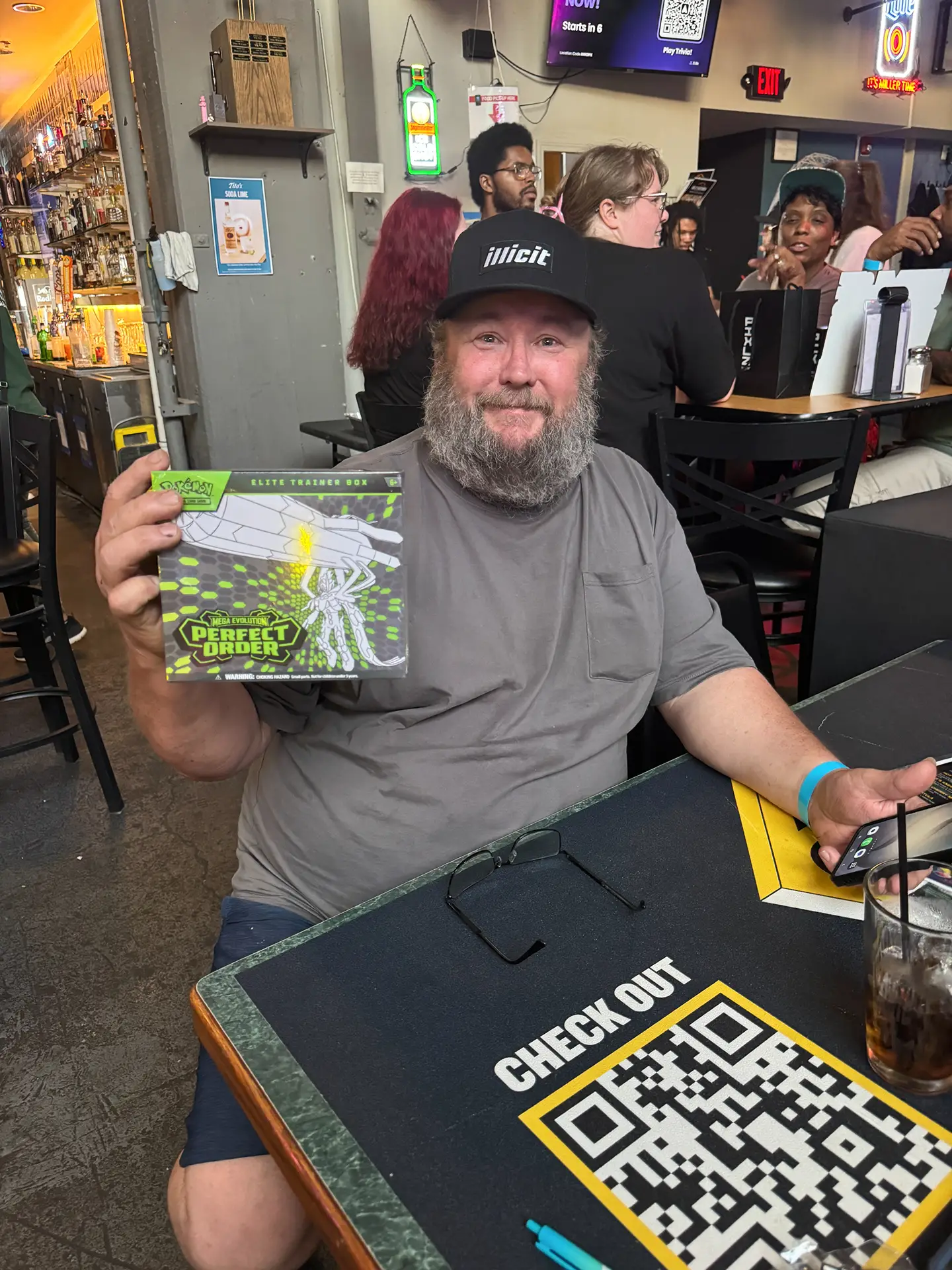 Man offers blue cannabis PIXLZ edible samples on skewers to two people at a Budsapalooza event booth.